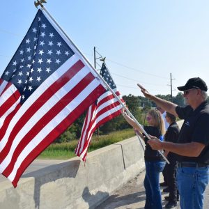 Sentinel Photo/TRAVIS MORSE WAVE THE FLAG — Litton Ambulance volunteer Terry Sledge was among those participating in Thursday morning’s Wave the Flag remembrance program in Jefferson County. During the event, first responders and other volunteers gathered at county overpasses to wave the flag and greet passing motorists, in honor of the Sept. 11 anniversary.
