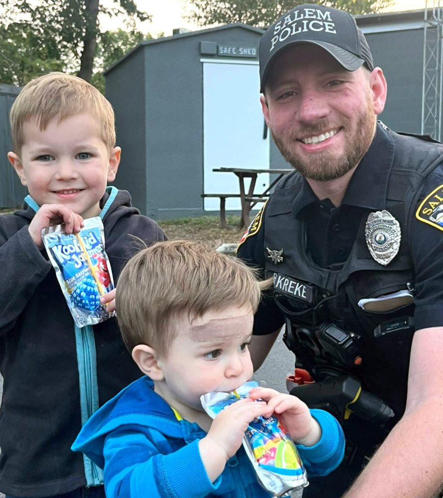 Submitted PhotoA REFRESHING DRINK — Officer Brandon Kreke from the Salem Police Department gave juice boxes to local youths Everett and Roper after spotting them in Salem recently.
